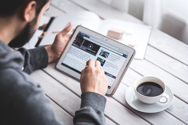 man reading a blog post online